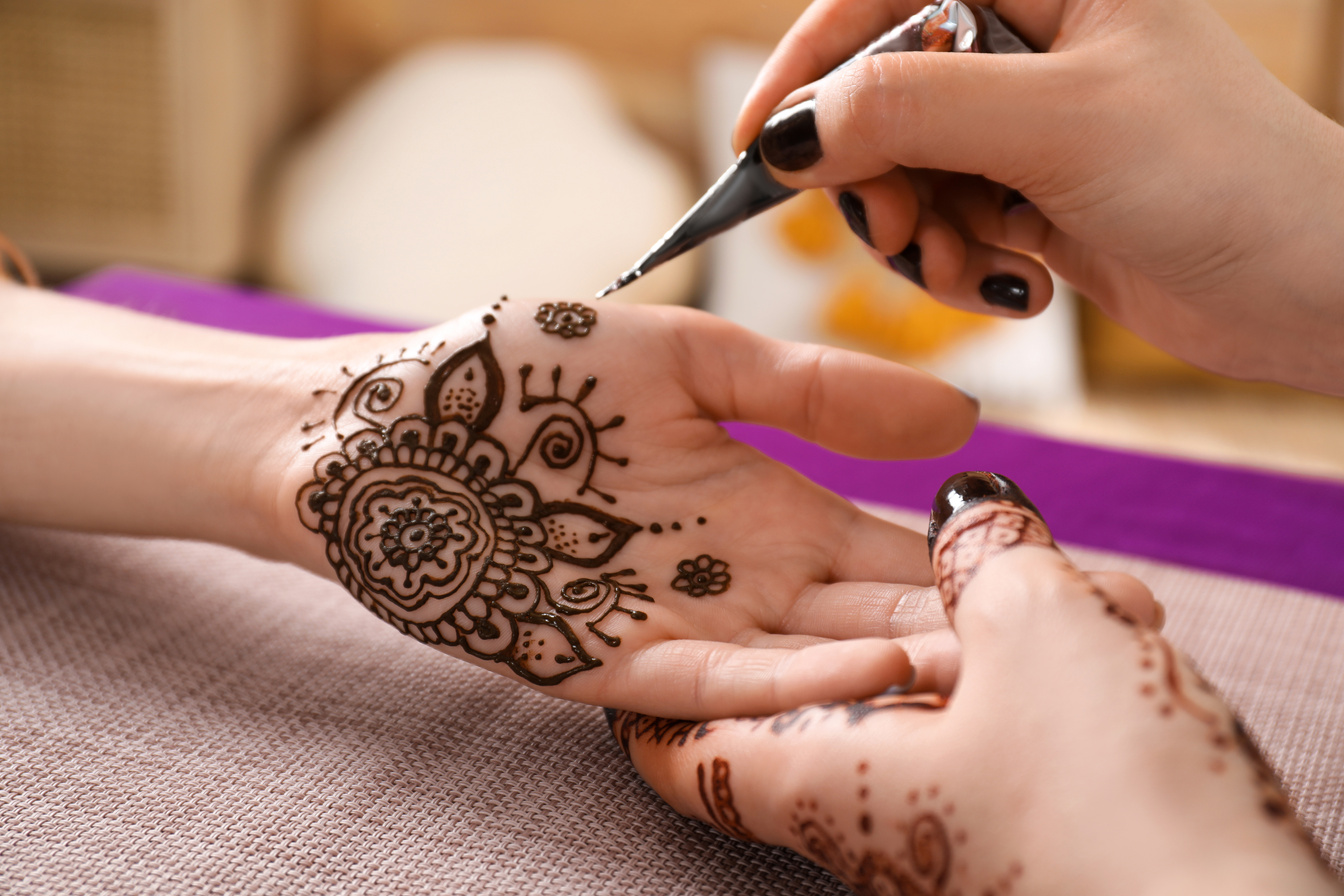 Professional Mehndi Master Making Henna Tattoo Indoors, Closeup